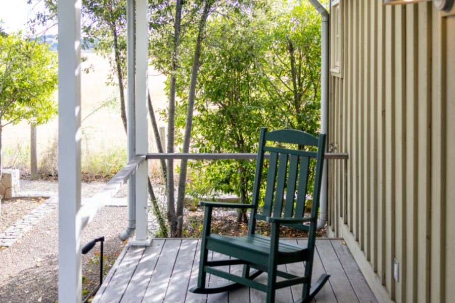 A quiet front porch with a rocking chair, seen in daylight