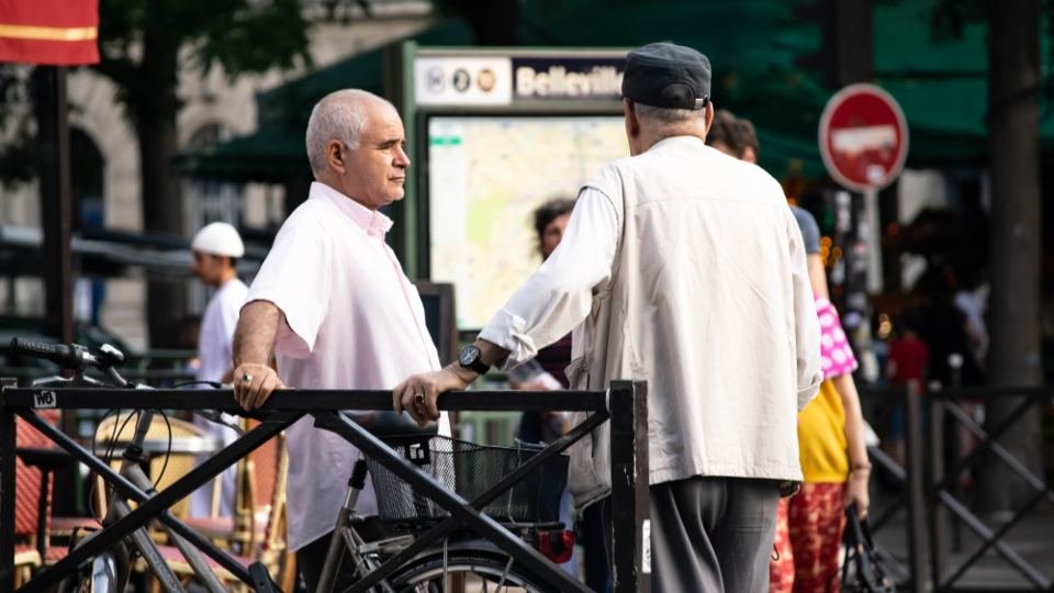 A busy neighbourhood street with people going about their day